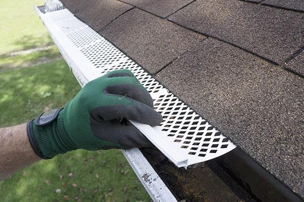 installing gutter guards can prevent debris buildup and clogging in your gutters, reducing the need for frequent cleaning and maintenance